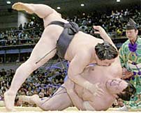 Asashoryu throws his opponant, Kaio, to the ground, winning the bout.